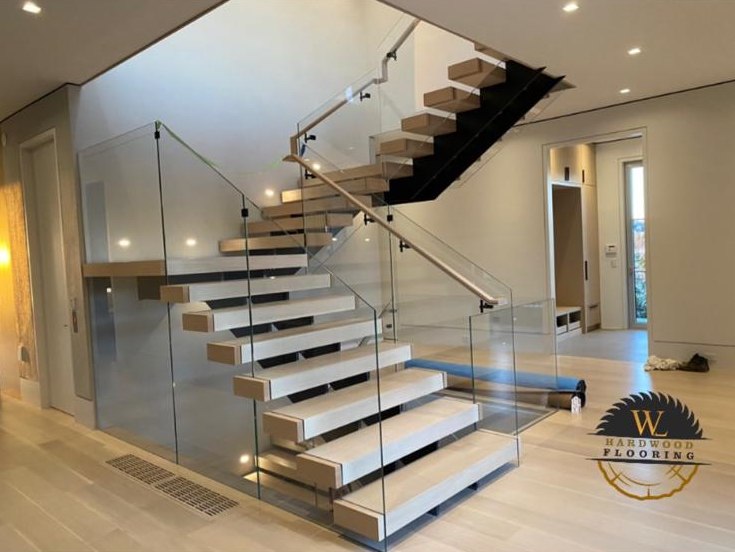 White oak treads on a floating glass staircase