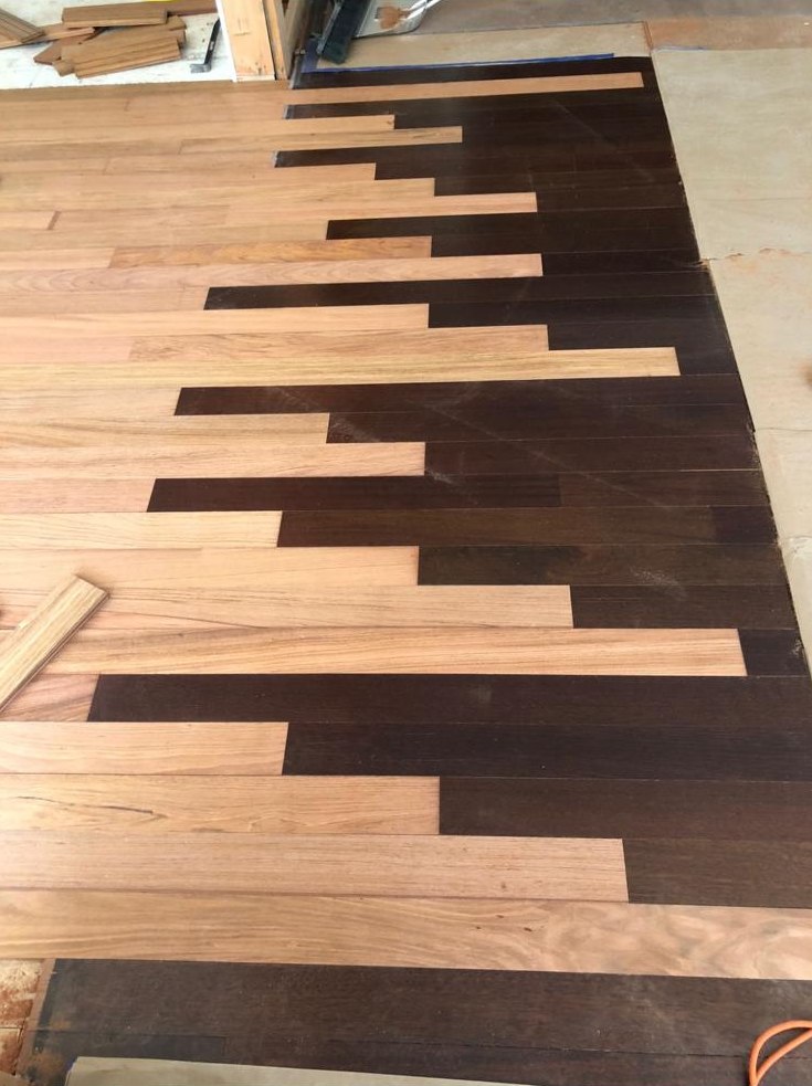 Custom two-tone floor layout with contrasting woods